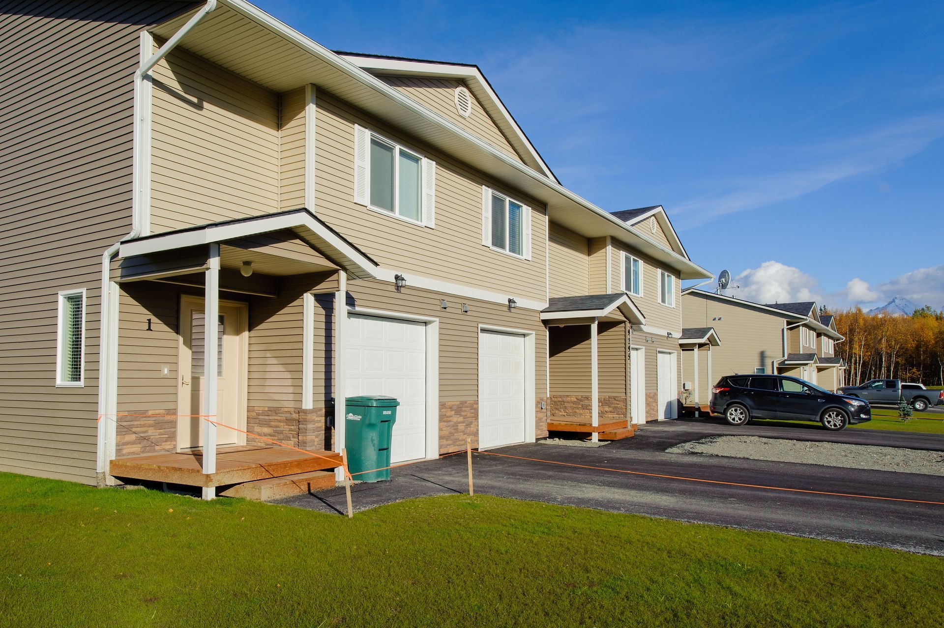 Row of managed Alaska townhomes on a clear fall day